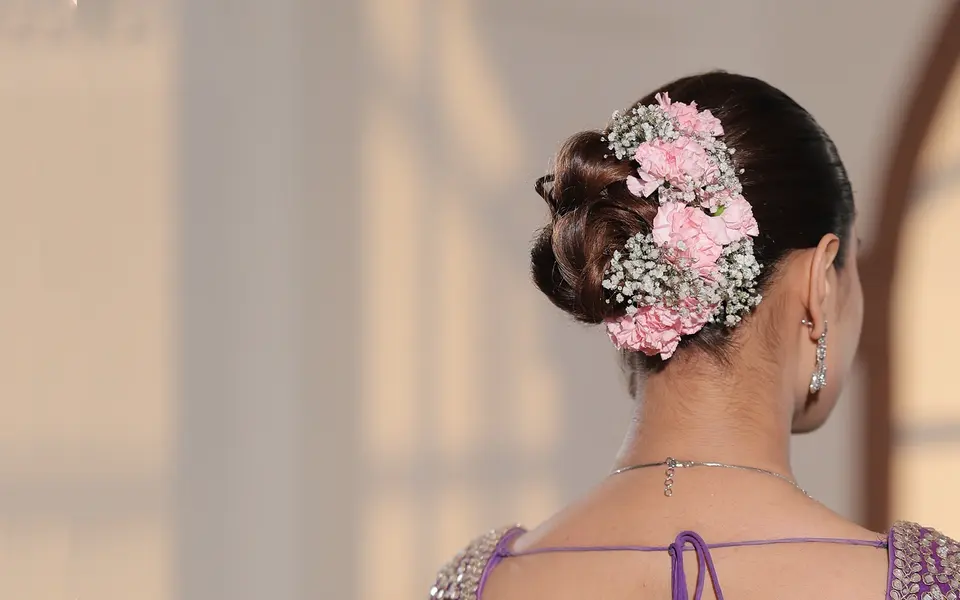 Floral arrangement around a bun, used as accessory-placement inspiration; starting hair length is unknown.